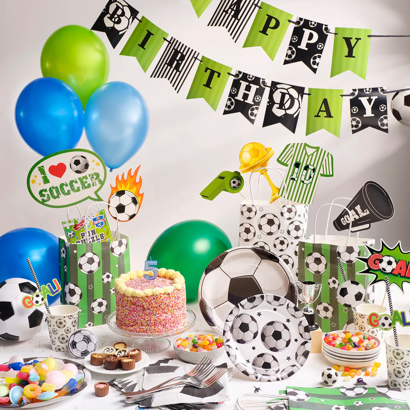 Kids Birthday Party Pack with a Football Theme. Includes a plastic Table Cloth, Paper Cups and Napkins, Paper Decorative Straws, Disposable Paper Plates, Photo Booth Props x25pcs, Happy Birthday Bunting Banner, fun Stickers and Paper Party Bags with Gifts inside, Party Balloons, Kids Party Games.