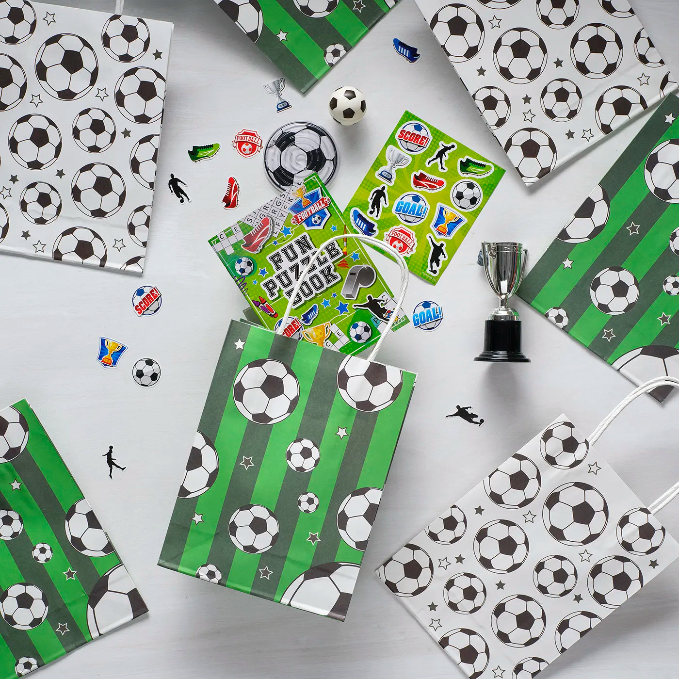Kids Birthday Paper Party Bags with a Football Theme. Includes stickers, trophy, puzzle, fun book and children’s Party Gifts inside.