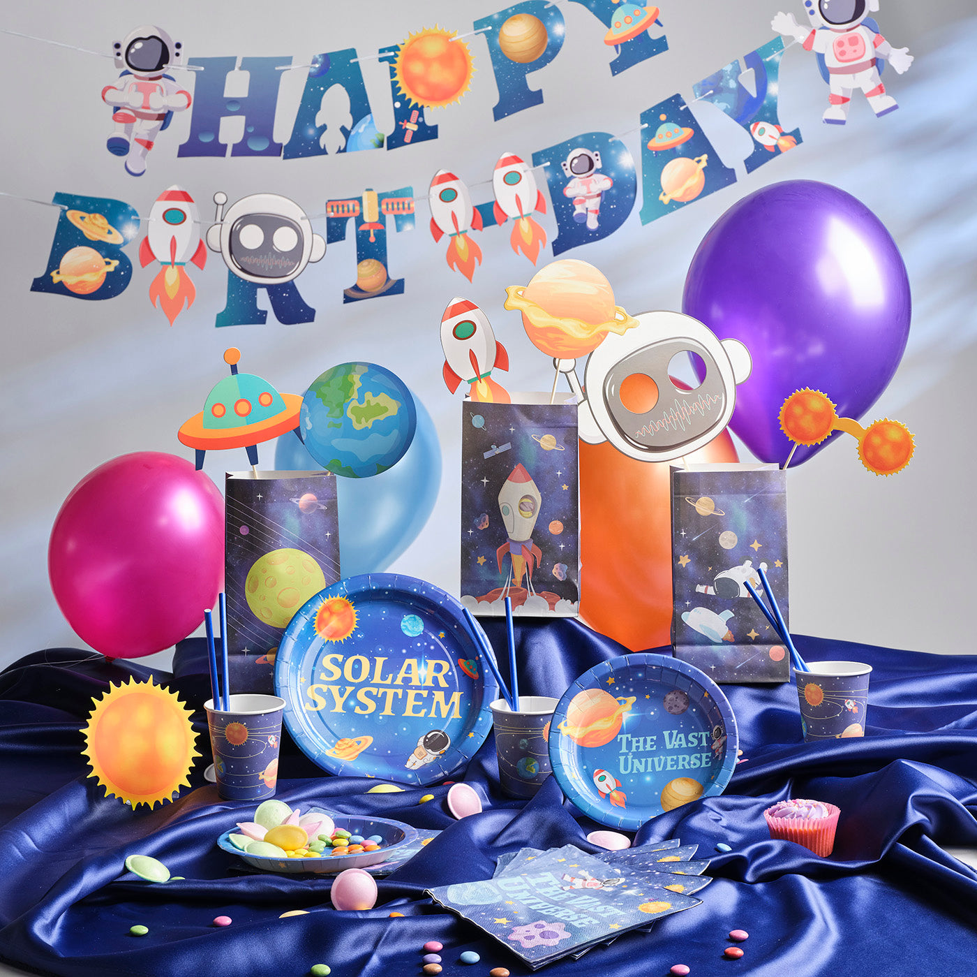 Kids Birthday Party Pack with a Space Theme. Includes a plastic Table Cloth, Paper Cups and Napkins, Paper Decorative Straws, Disposable Paper Plates, Photo Booth Props x25pcs, Happy Birthday Bunting Banner, fun Stickers and Paper Party Bags with Gifts inside, Party Balloons, Kids Party Games.